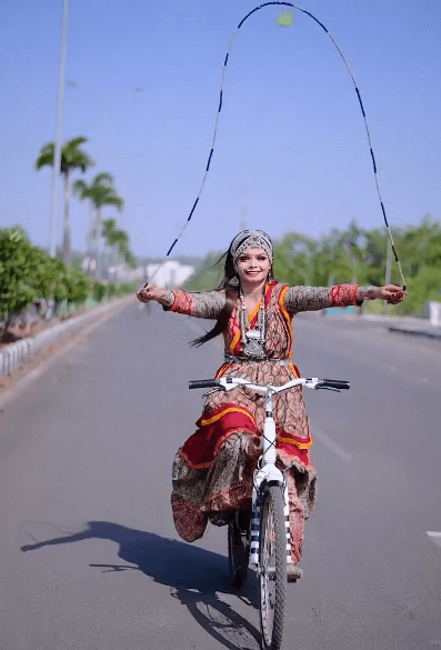girl jumped rope on a running bicycle wearing a chaniyacholi